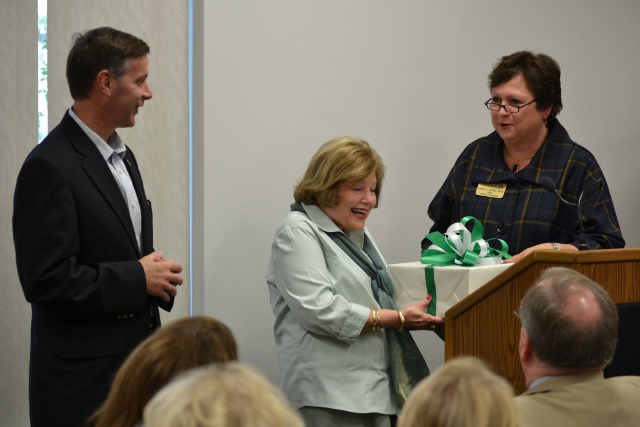 PHOTO:  Dr. Janie Allen-Bradey (center) receives a gift of hand carved bookends from Delta State Foundation Executive Director Keith Fulcher (left) and Dean of the College of Arts and Sciences Dr. Leslie Griffin.